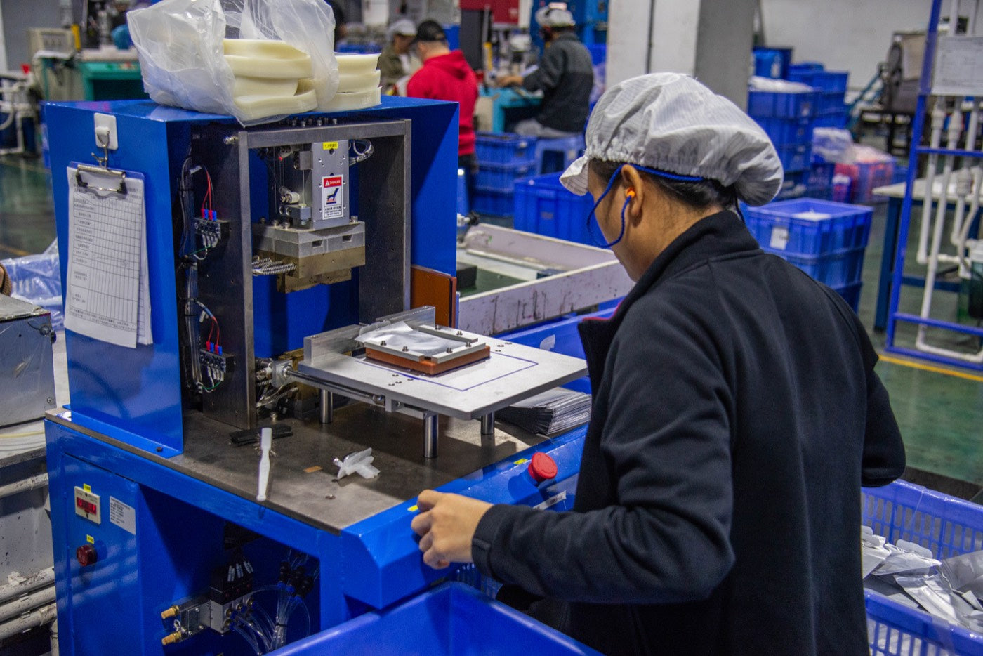 Yescolor worker operating production equipment during manufacturing